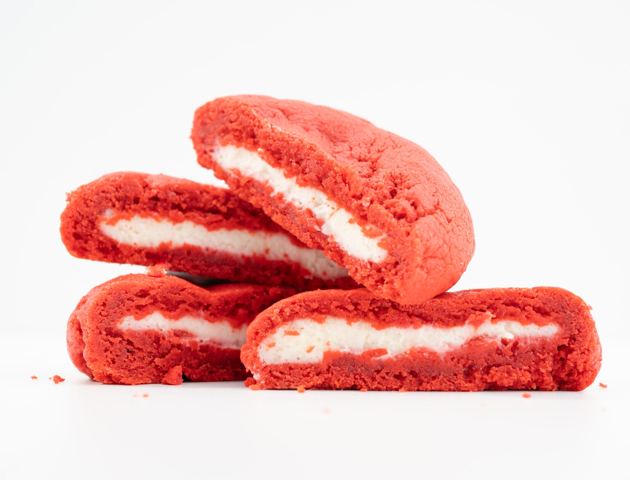 Freebirds red velvet cream cheese cookie stacked on white background