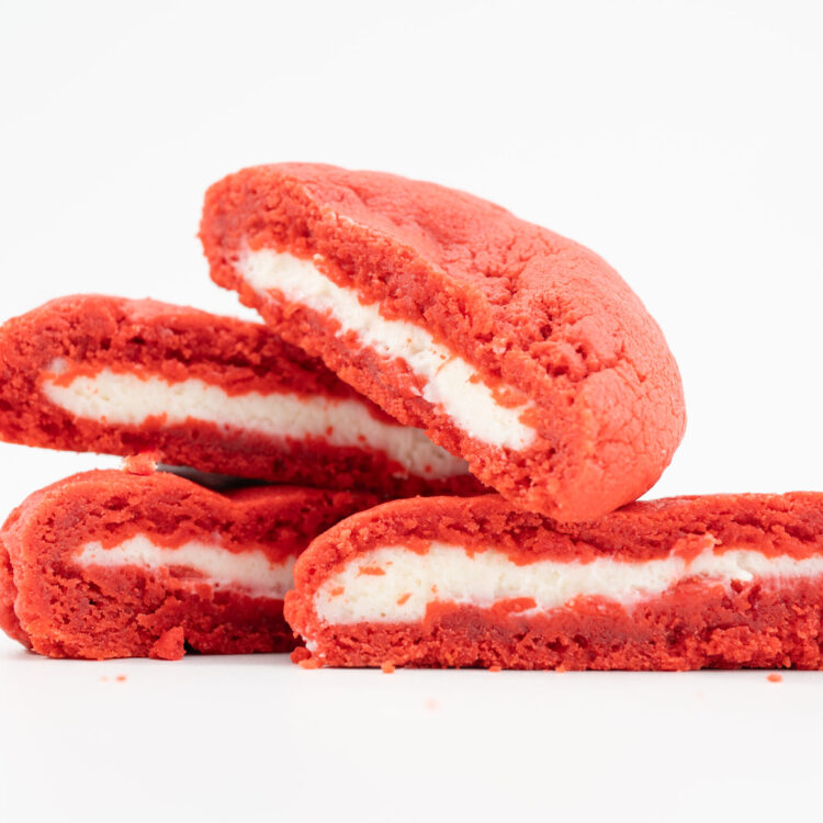 Freebirds red velvet cream cheese cookie stacked on white background