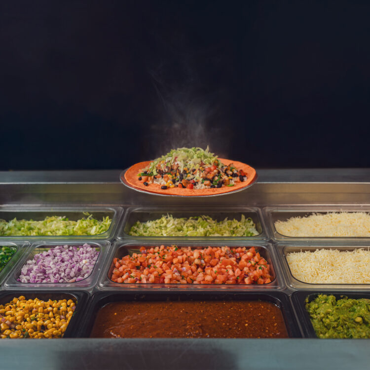 Freebirds ingredient line with burrito above fresh toppings for It’s Your World campaign