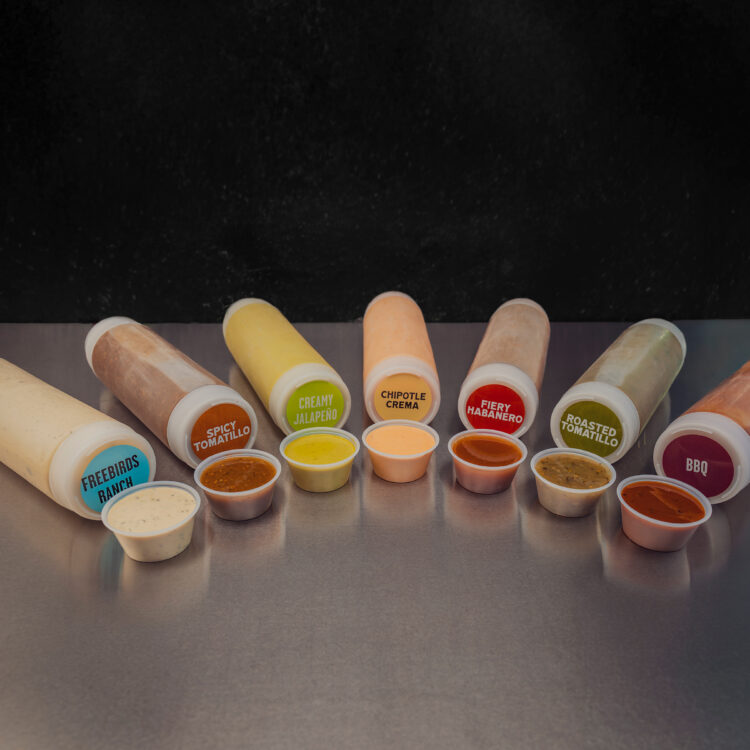 Freebirds sauce lineup featuring ranch, spicy tomatillo, creamy jalapeño, chipotle crema, fiery habanero, roasted tomatillo, and BBQ