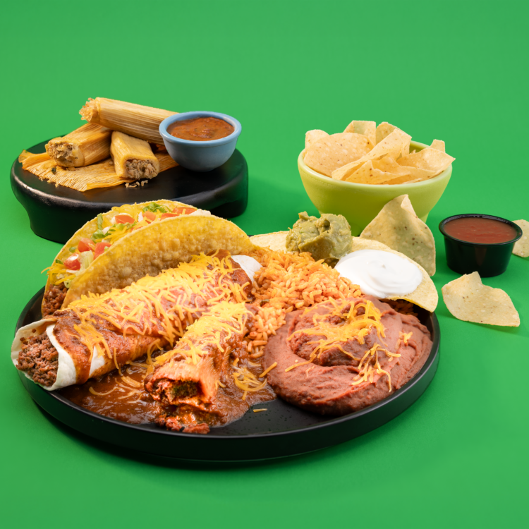 Taco Bueno holiday tamales combo platter with chips, salsa, guacamole, rice, beans, and tamales